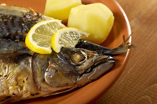 Mackerel on a grill. Fish prepared  with vegetables