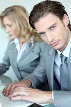 Businessman and woman on the computer