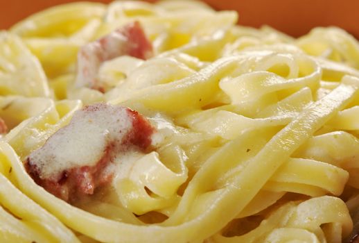 pasta Fettuccine Alfredo with sausage. close-up