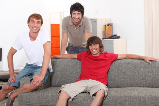 Three lads relaxing at home