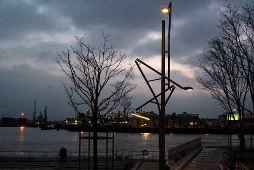 Beautiful view of the cranes and refinery logistics at the harbour of Hamburg at dusk