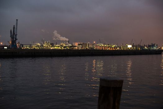 Beautiful view of the cranes and logistics at the harbour of Hamburg at dusk