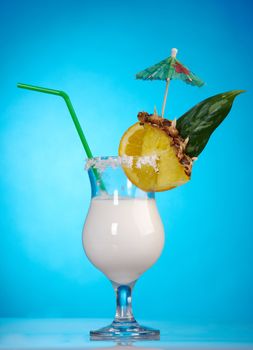 Pina Colada - Cocktail with Cream, Pineapple Juice and Rum on blue background