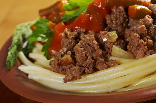 pasta with  beef ,vegetable  tomato sauce  on wooden table