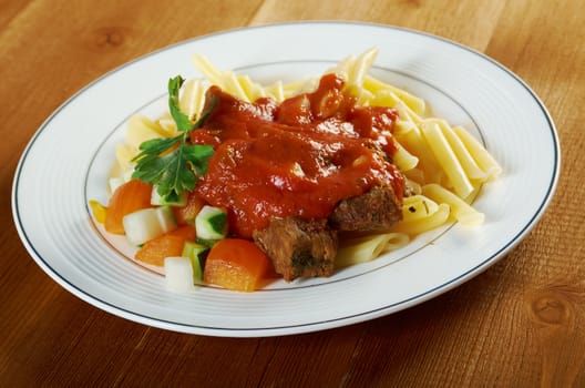  pasta with tomato beef sauce  on wooden table