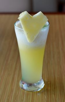 Smoothie  of pineapple served with slice of pineapple