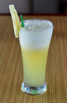 Smoothie  of pineapple served with slice of pineapple