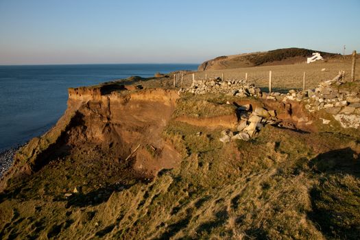 The coast path ends at a landslip and crumbling stone wall above, West Shore, Trefor, Lleyn peninsular, Wales, UK.