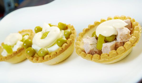 tartlet with salad on a white plate .Shallow depth-of-field