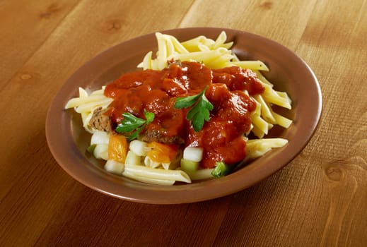  pasta with tomato beef sauce  on wooden table