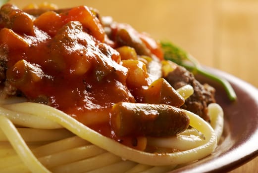  pasta with  beef ,vegetable  tomato sauce  on wooden table