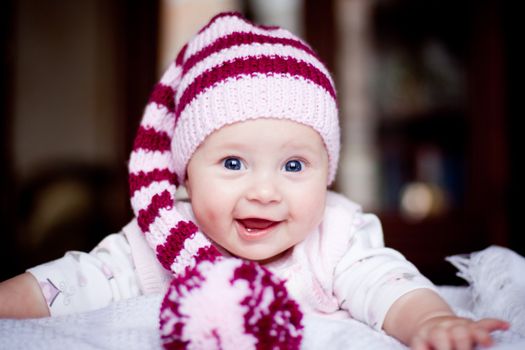 cute baby in a striped purple hat with pompom