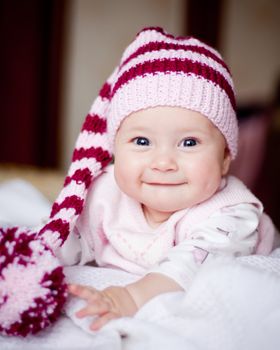 cute baby in a striped purple hat with pompom