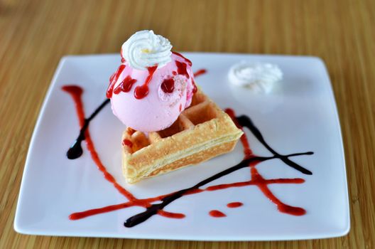 Waffle and whipping cream with strawberry ice cream