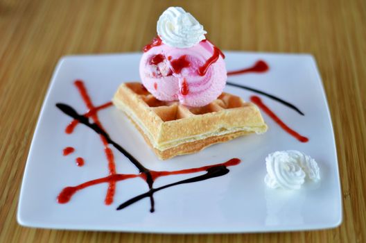 Waffle and whipping cream with strawberry ice cream