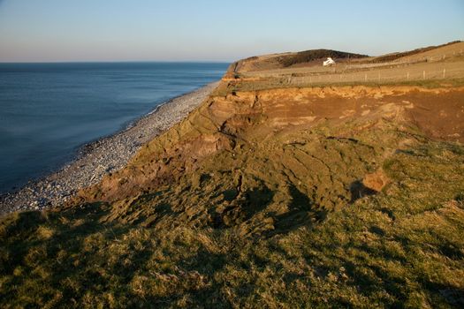 The Wales coast path passes next to a landslide above West Shore, Trefor, Lleyn peninsular, Wales, UK.