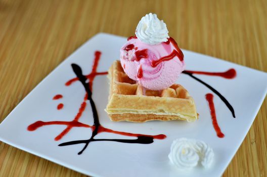 Waffle and whipping cream with strawberry ice cream