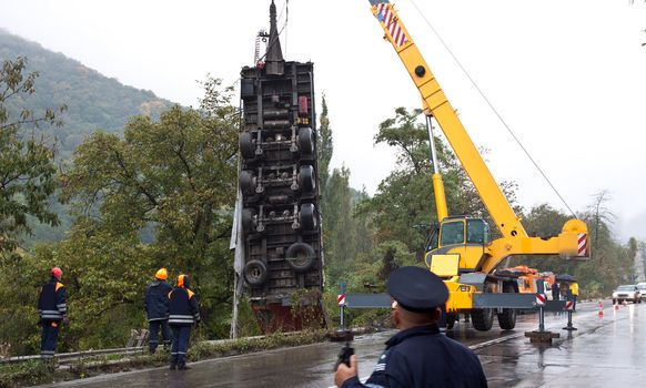 Crane lifting a truck after crash accident