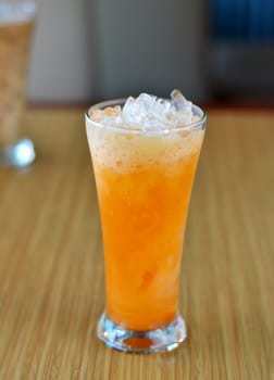 ice orange tea with fresh milk in glass