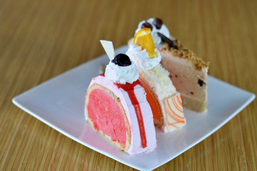 three of  ice cream cake ,orange  strawberry and chocolate