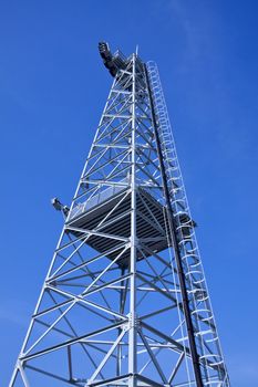 Electric transmission tower under blue sky
