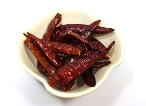 Dry red chili pepper in a  bowl isolated on white background