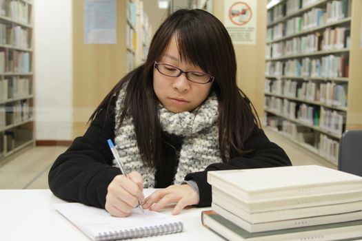 Asian girl studying in library