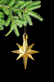 gold(en)  star on black background,Christmas bauble