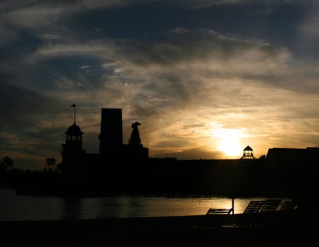 The silhouettes of a hotel at sunset.