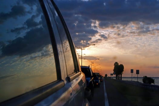 A reflection of a traveling car in the sunset.