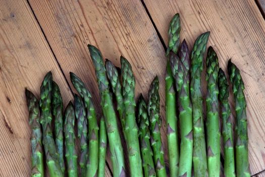 Asparagus heads on a bench in the garden