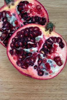 Sliced Pomegranate showing the seeds, on a chopping board