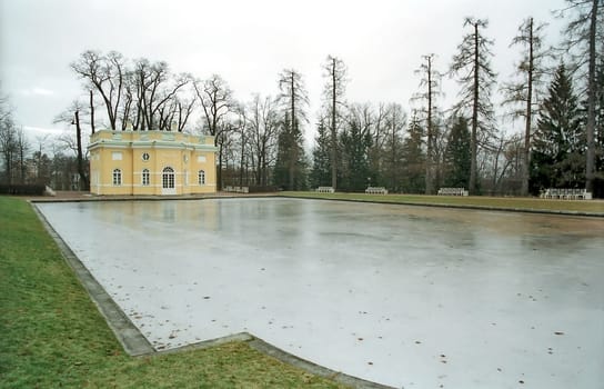  Iced pond and classical buiding in winter park