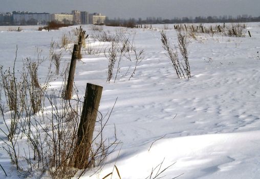 Snow field outside town with new buildings