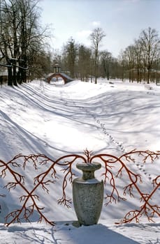 Decoration of stone vase with red branches on snow background
