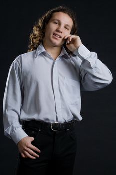 Portrait of man handing phone on black 
