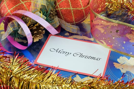 Close up of a Merry Christmas note among decorations