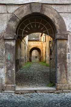 Old Italian portal with open gate