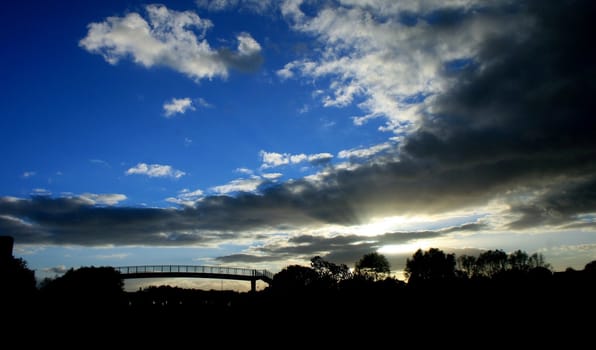 A silhouette of a bridge in sunset.