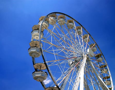 A ferris wheel in a fair ground.