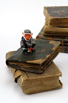 old religious books and monkey statuette