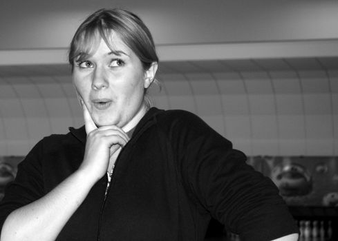 Victoria posing, thinking in a bowling alley.