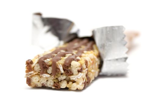 Wrapped healthy granola bar isolated on a white background.