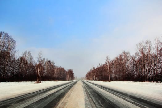 Image of winter road and cloudy sky