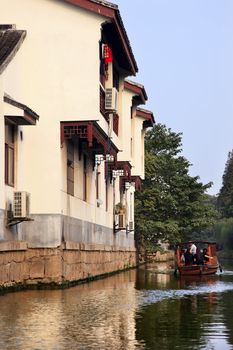 PANMEN GATE SCENIC AREA CANAL SUZHOU CHINA 10/29/2010
Wooden Boat on the Canal Ancient Chinese Houses Reflection in Water, Suzhou, Jiangsu, China