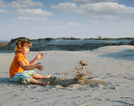 little girl playing in the sand