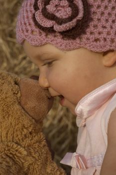 Little girl is kissin her bear toy,sweet emotional photo