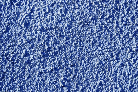 Blue painted textured walls closeup macro background details.