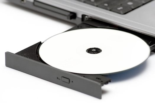 Blank disc in DVD drive. White background.