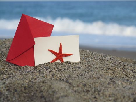 Decorative red  envelope on sand background